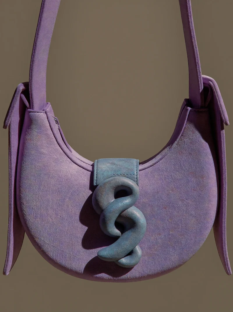 Illustration: kompakte Halbmond-Crossbody mit eigenem Verschluss